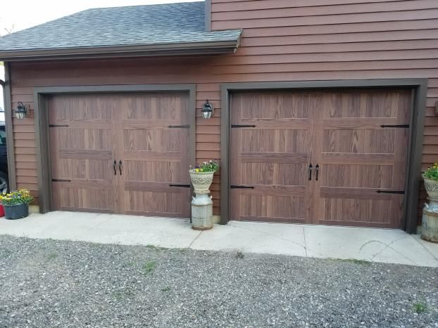 These are 9'x 7' CHI Model 5916 Carriage House Doors with Dark Accents and traditional Hardware. What a great addition to the homeowners new siding, making it all a beautiful maintenance free improvement to enjoy for years to come.